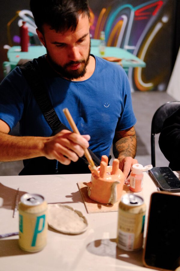 a person painting a clay sculpture